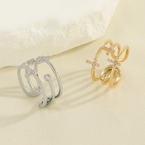 Detail of gold and silver multi-layer cross rings with inlaid colorful zircon stones