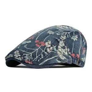 Vintage floral pattern blue denim flat cap with adjustable metal buckle on white background