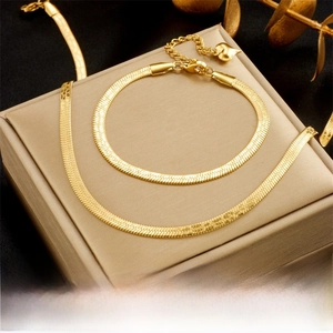 Detail of gold-plated flat snake chain set with lobster clasp and heart charm