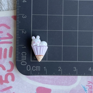 Macro detail of a resin bunny ice cream cone miniature measuring 3.5cm on a scale mat