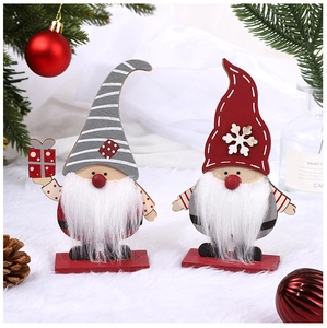 Close-up of wooden Christmas gnomes with grey striped and red snowflake hats on red bases
