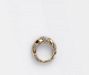 Macro view of gold twisted rope ring featuring sparkling pave diamond micro-inlays