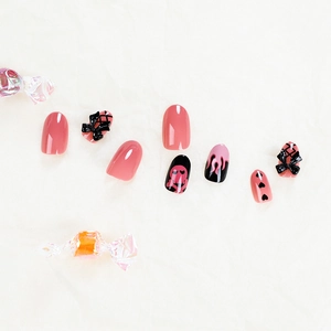 Pink and black flame press-on nails with 3D bows and heart skull punk style designs