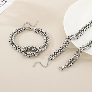 Minimalist double-layered stainless steel chain set with knot detail and silver finish