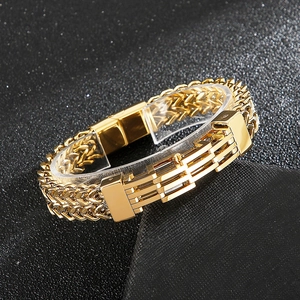 Detailed macro view of heavy gold stainless steel chain bracelet with a polished metal bar