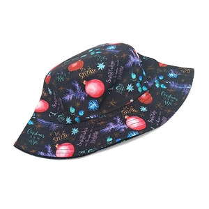 Detail of Christmas bucket hat with Let it Snow prints and festive snowflake patterns
