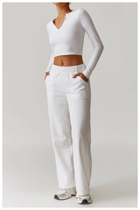 Detail of white deep V-neck yoga top and elastic waistband sports pants fabric texture