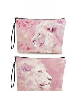 Detail view of pink lion and floral print on portable makeup bag with black zipper strap
