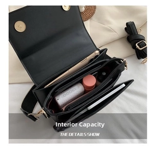 Macro view of compact black crossbody bag interior with large capacity and compartments