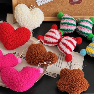 Close-up of soft lamb wool Christmas ornaments in heart, star and bow shapes