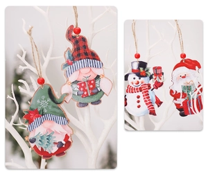 Close-up of vintage wooden gnome and snowman pendants hanging on a white branch