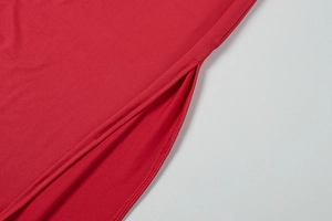 Detailed close-up of side slit design on this elegant red sleeveless dress fabric