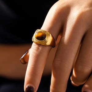 Vintage textured oval tiger eye ring with gold-plated titanium steel finish on hand