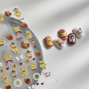 Detailed 3D embossed nail stickers featuring cute teddy bears, red gift boxes and hearts