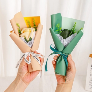 Mini soap rose bouquets in peach and green wrapping for Valentine gift or wedding favor