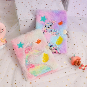 Detailed view of plush mermaid tail notebook with gradient faux fur and metal lock