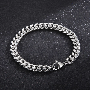 Close-up of polished silver stainless steel Cuban chain bracelet with lobster clasp