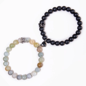 Detail of magnetic heart clasp connecting crown natural stone couple bracelets