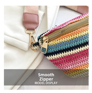 Detail of smooth gold zipper and bohemian colorful woven fabric on the straw waist bag
