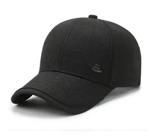Detail view of black baseball cap featuring a side metal logo and breathable eyelets