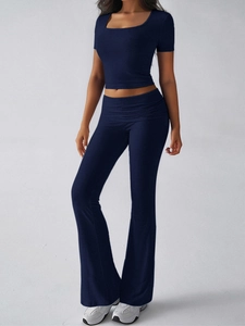 Detail of navy blue two-piece Y2K sporty set with square neck crop top and flared pants