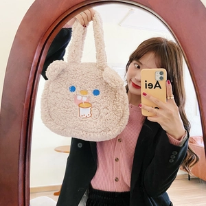 Detail view of beige fuzzy lamb plush tote bag with cute bear ears and embroidery