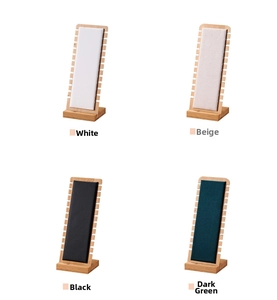 Bamboo necklace display stands in white, beige, black, and green leather and velvet finishes