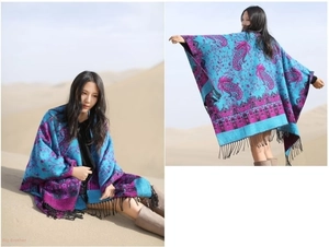 Close-up of blue bohemian cashmere shawl with paisley patterns and black tassel fringe