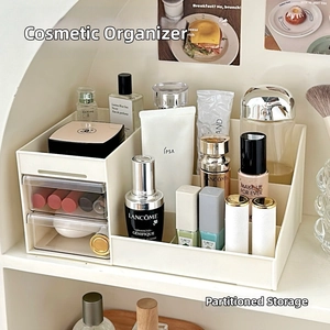 Detail view of white cosmetic storage box with dual transparent drawers and tiered sections
