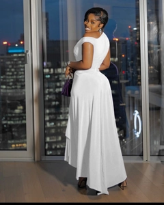 Detailed back view of white one-shoulder maxi dress with asymmetric hemline on model