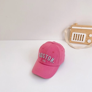 Detail of pink cotton baseball cap for kids with white Boston embroidery on a white background