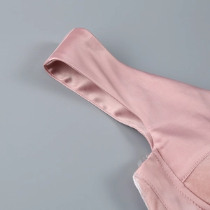 Detailed close-up of pink velvet and satin stitching on off-shoulder dress straps