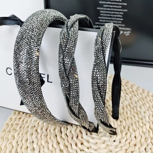Three-piece French rhinestone headband set with braided patterns on straw mat background