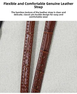 Detail of a brown leather watch strap with bamboo embossed texture and silver buckle