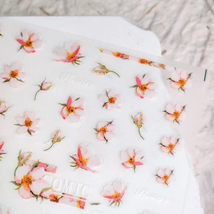 Floral nail art stickers with pink cherry blossoms and green leaves on clear adhesive