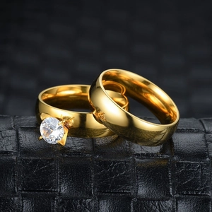 Macro shot of 18K gold plated stainless steel couple rings with zircon stone detail