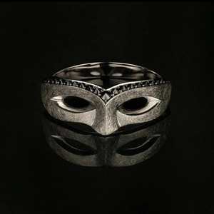 Minimalist Masquerade Mask Ring with black stones in brushed finish on black background