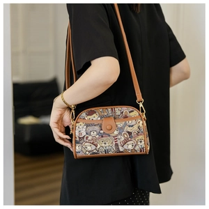 Side view of bear print canvas crossbody bag on model showing adjustable strap and texture