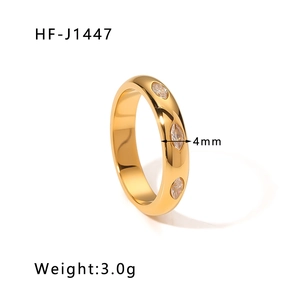 Macro detail of 4mm gold-plated stainless steel ring with marquise-cut white zircons
