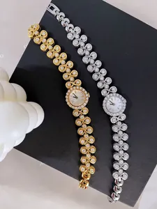 Close-up of luxury vintage watches with infinity-link bands and rhinestone pavé settings