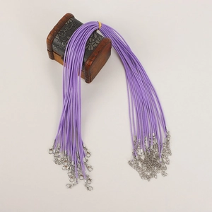 Detail view of purple waxed necklace cords with metal lobster clasps and extension chains