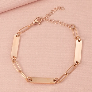 Detail of rose gold paperclip chain bracelet with a blank bar and adjustable lobster clasp