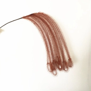 Detailed view of single brownish-red artificial pampas grass with fine fiber texture