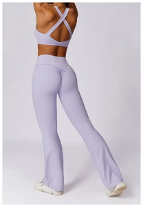 Close-up of lilac yoga set featuring cross-back sports bra and scrunch butt flared leggings