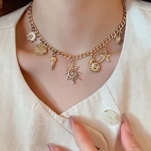Gold multi-pendant ocean theme necklace with starfish and shell charms for summer