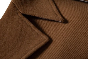 Close-up of caramel wool coat lapel showcasing premium fabric texture and stitching detail