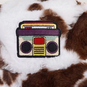 Close-up of retro radio embroidery on thick cow print faux fur fisherman hat