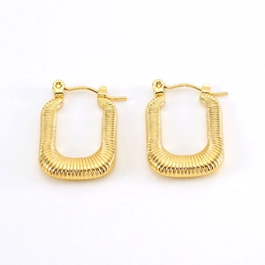 Detailed macro of gold plated square hoop earrings featuring vertical textured stripes