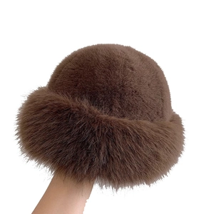 Thick dark brown faux fur bucket hat with plush texture for winter warmth