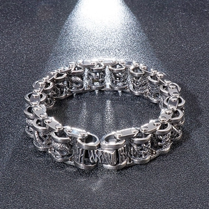 Detailed view of heavy-duty stainless steel bike chain bracelet with dragon engravings